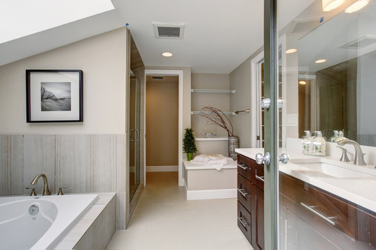 Luxury master bathroom with white tile floor.
