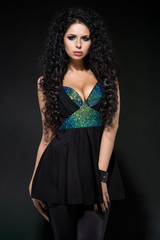 Beautiful woman in black on dark background
