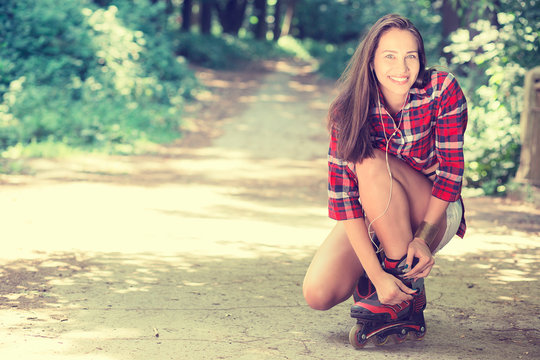 Girl going rollerblading sitting putting on in line skates outdo