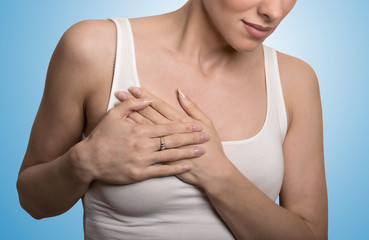 cropped portrait young woman with breast pain touching chest