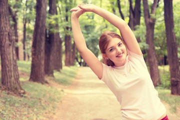 Fitness woman stretching exercises on fresh air