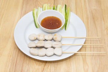 pork meat ball grilled and sauce on wood background