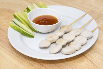 pork meat ball grilled and sauce on wood background