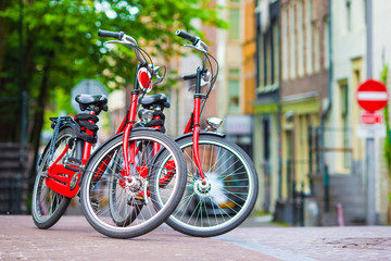Fototapeta na wymiar Red Bikes on the bridge in Amsterdam, Netherlands
