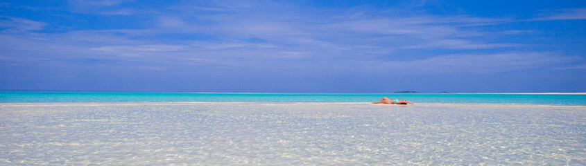 Young beautiful woman at shallow tropical water