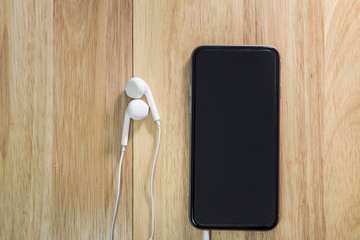 smart phone and note on wooden background