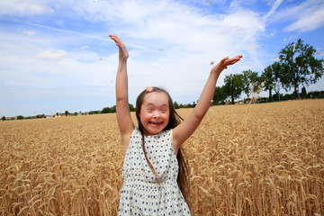 Young girl have fun in the wheat field