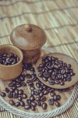 Coffee beans and coffee cup set on bamboo wooden background.Phot