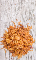 Deep fried shallots for garnishing over wooden background