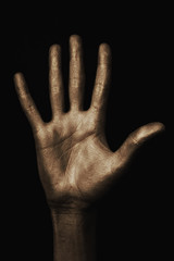 Fototapeta premium beautiful man's hand in golden paint on black background