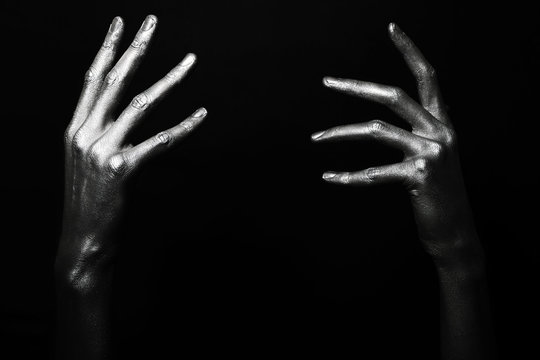 male hands in silver paint