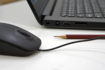 Pencil and computer on desk