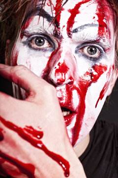 mime with blood on face and hand