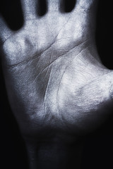Man's hand in silver paint