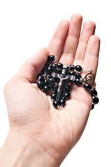 hand holding wooden rosary with Catholic crucifix