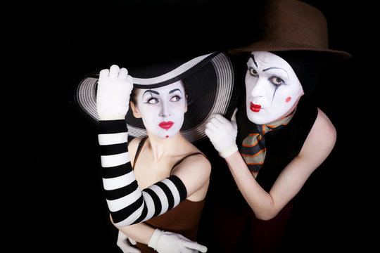 Portrait of two mimes in white gloves