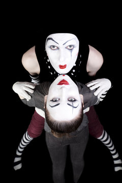 two mimes on black background