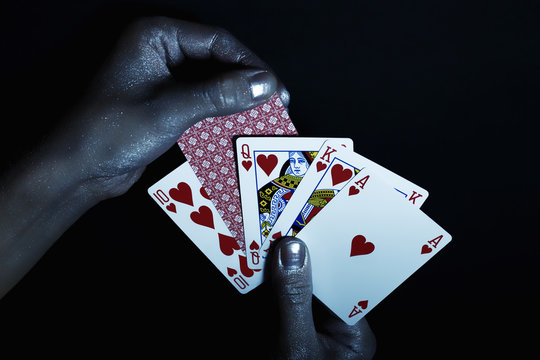 Metal men's hands with playing cards