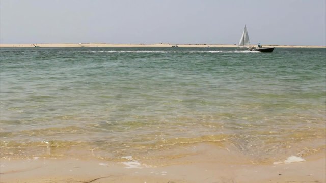 Boat crossing view in Armona island inlet, at Ria Formosa wetlands. Algarve
