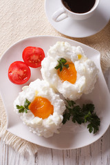 breakfast: eggs Orsini and coffee close-up. vertical top view
