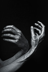 beautiful man's hands in silver paint