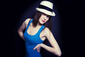 Fototapeta premium portrait of young blue-eyed girl in white hat