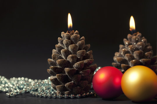 Two candles as a candle with christmas-tree decorations