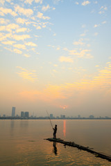 Fisher man on the west lake, hanoi, vietnam