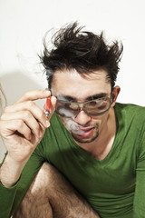 Obraz premium young guy with a cigarette in sunglasses