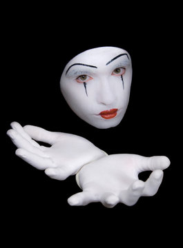 mime in white gloves on  black background