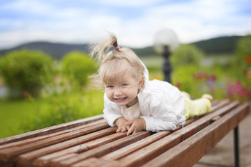 Smiling girl lying on the bench