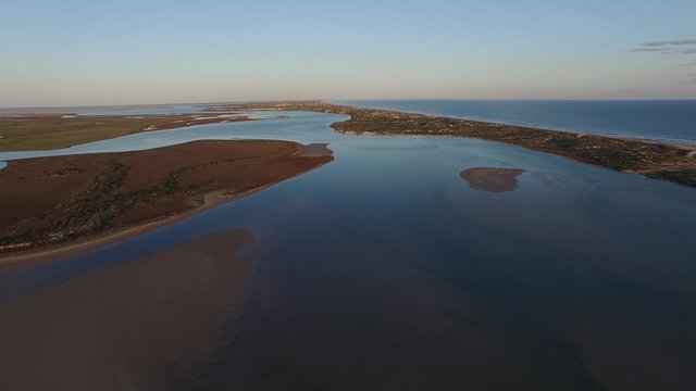 Wide Aerial video elevated view of river murray mouth in coorong and lower lakes. Famous place for coorong sandhills, sand dunes, wetlands, fishing and and boating in South Australia