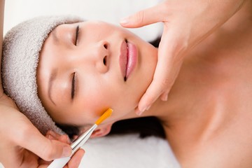 Obraz na płótnie Canvas Attractive woman receiving massage at spa center