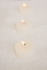 Fototapeta na wymiar Close up of three lightened candles