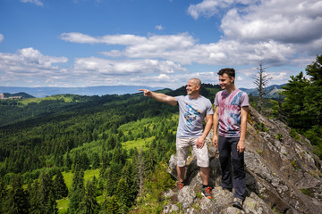 Father and son standing on a mountain top