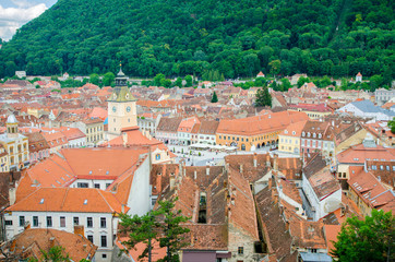 Naklejka na ściany i meble Brasov, Romania - 29.06.2015: Brasov old historic medieval city center in a view from above with the town hall and Sfatului Square showing the cultural and historic heritage in the Romanian city