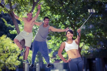Obraz premium Smiling extreme athletes taking selfies with selfiestick 
