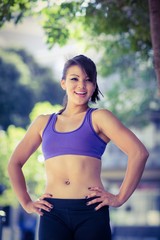 Fototapeta premium Portrait of smiling athletic woman looking at camera