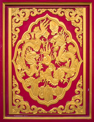 The Chinese gold dragon sculpture on a red wall ( focus to a crop picture )