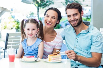 Portrait of a family eating at the restaurant