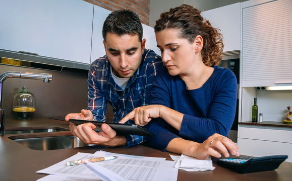 Couple reviewing their accounts with a digital tablet