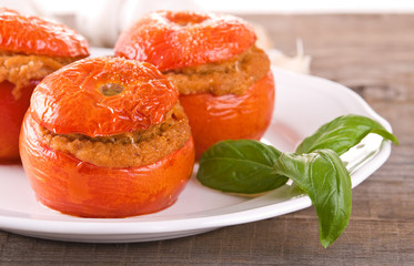 Stuffed tomatoes on a white plate. 