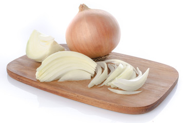 Whole and sliced onions on a cutting board