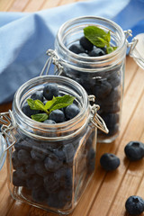 Glass jars with fresh blueberries