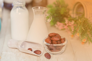 Almonds caramel with milk on table. Selective focus, shallow DOF