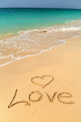 Love sign on the beach with turquoise water