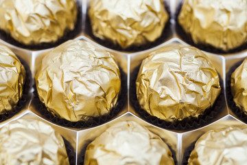 Chocolate balls with almond in gold foil paper 