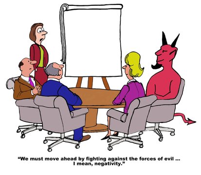 Business cartoon showing people at a meeting, including the devil.  Leader says, 'we must move ahead by fighting against the forces of evil... I mean negativity'.