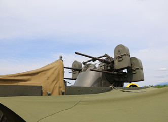 Fototapeta na wymiar military truck with a deadly machine gun on the roof