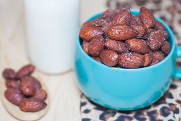 almonds  in cup on table. Selective focus, shallow DOF